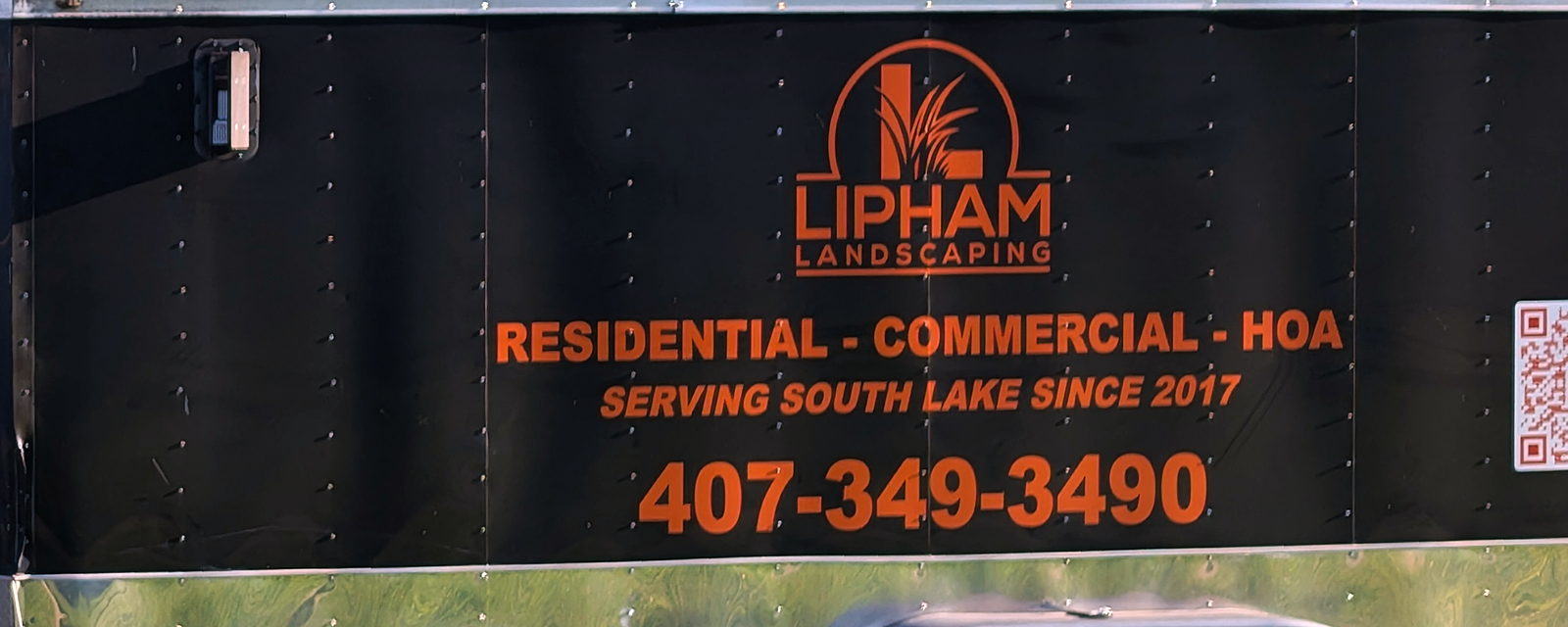 Lipham Landscaping trailer panel reading Residential, Commercial, HOA — Serving South Lake since 2017 — 407-349-3490