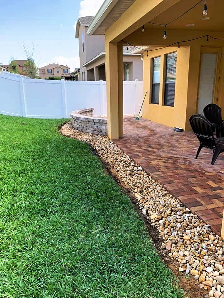 Finished work at a client's home - new paver walkway, river rock border and fresh sod