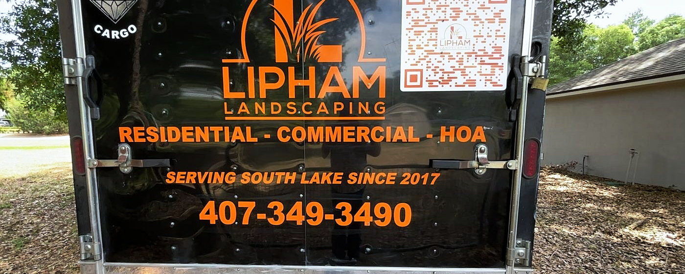 The back of the Lipham Landscaping trailer reading Residential, Commercial, HOA